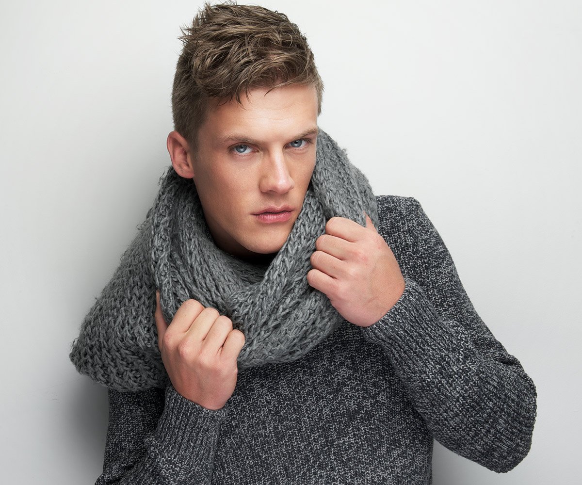 Man in gray sweater and scarf portrait