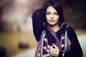 Woman posing outdoors in patterned sweater