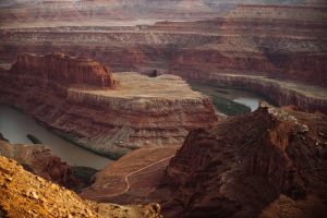 Aerial view of Grand Canyon with river and cliffs.