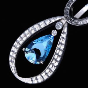 Elegant diamond and blue gemstone pendant
