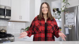 Person in kitchen wearing red plaid shirt