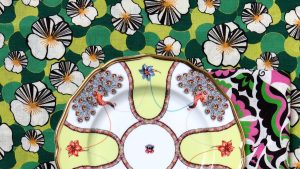 Floral plate on colorful patterned fabric