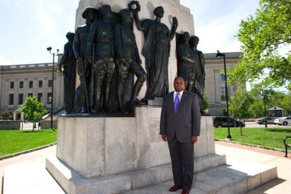 Man standing beside historical monument outdoors